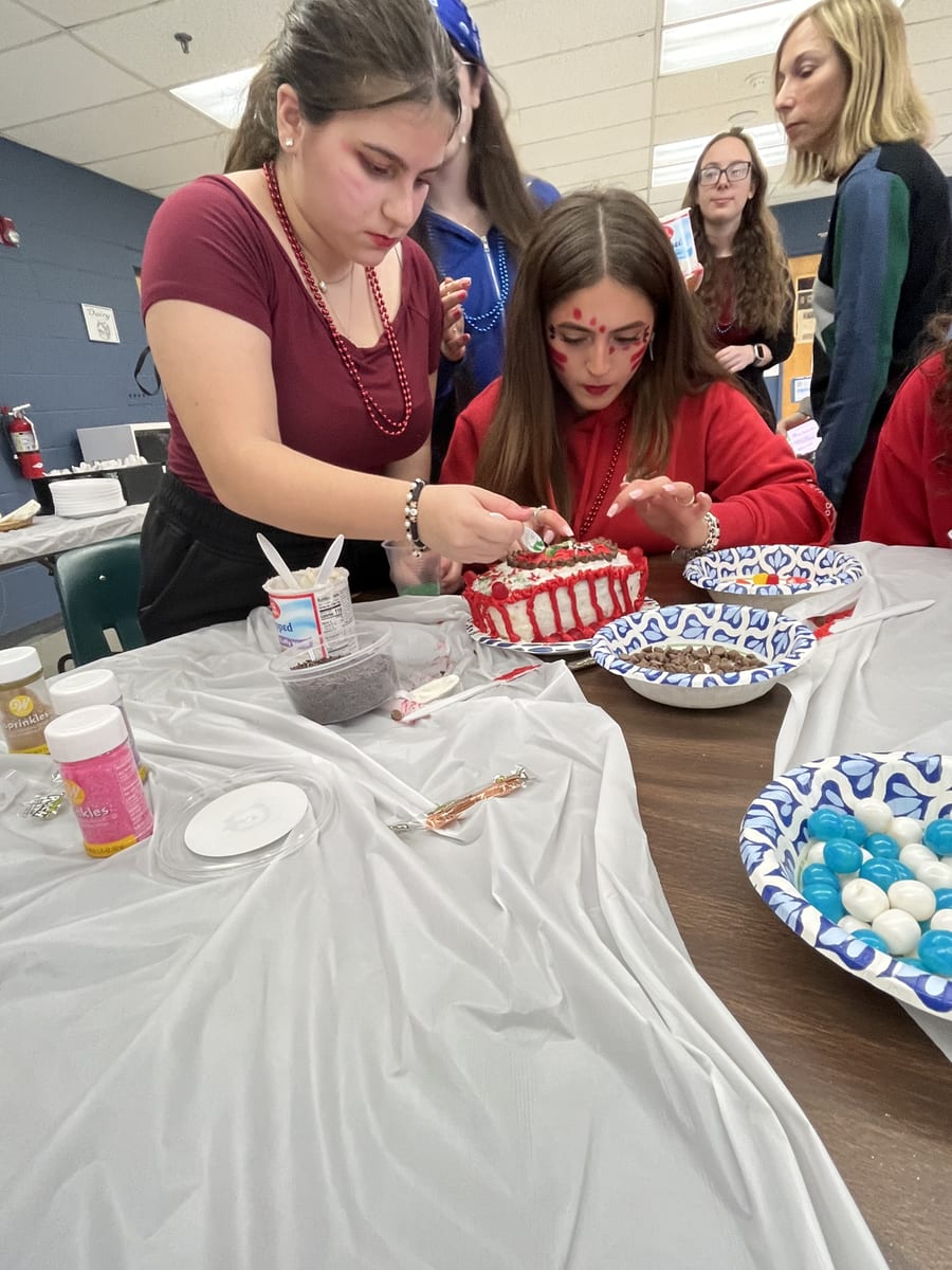 WHHS students decorating a cake during Color War
